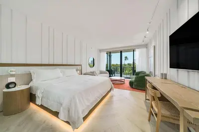 a bedroom with a large bed and a television at SOUTH BEACH Stunning Studio in Miami Beach