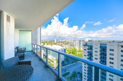a balcony with chairs and a view of a city at Condo w Breathtaking Views & Top Amenities in Hollywood