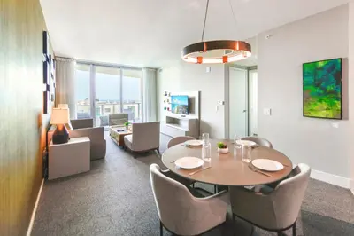 a room with a table and chairs and a living room at Condo w Breathtaking Views & Top Amenities in Hollywood