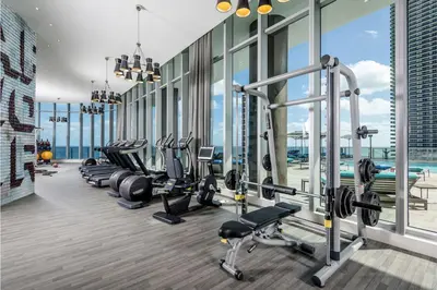 a gym with a row of treadmills and machines at Condo w Breathtaking Views & Top Amenities in Hollywood