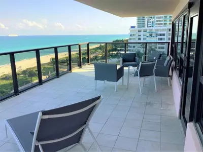 a balcony with chairs and a view of the ocean at Alexander 1001 in Miami Beach
