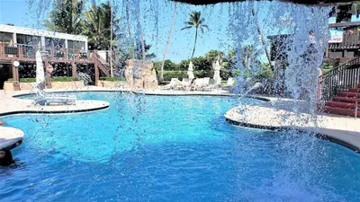 a swimming pool with a fountain in a resort at Alexander 1010 in Miami Beach
