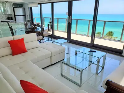a living room with a white couch and a glass table at Alexander 1101 in Miami Beach
