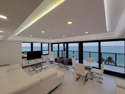 a living room with a white couch and a television at Alexander 1102 in Miami Beach