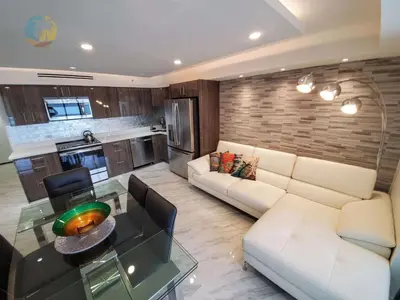 a living room with a white couch and a glass table at Alexander 1103 in Miami Beach