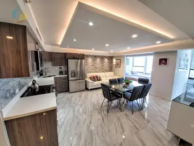 a kitchen and a living room with a table and chairs at Alexander 1103 in Miami Beach
