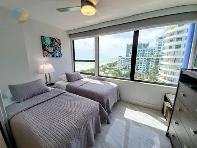 a bedroom with two beds and a large window at Alexander 1103 in Miami Beach