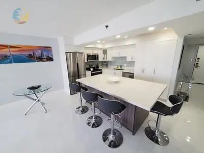 a kitchen with a white counter and bar stools at Alexander 1104 in Miami Beach