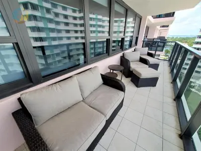 a living room with a couch and chairs on a balcony at Alexander 1104 in Miami Beach