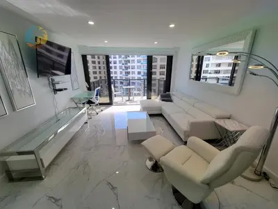 a living room with white furniture and a large window at Alexander 1115 in Miami Beach