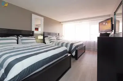 a hotel room with two beds and a window at Alexander 1119 in Miami Beach