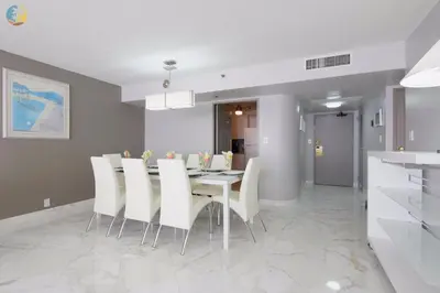 a dining room with a table and white chairs at Alexander 1119 in Miami Beach