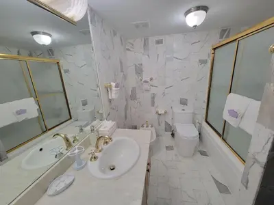 a white bathroom with a sink and a toilet at Alexander 1119 in Miami Beach