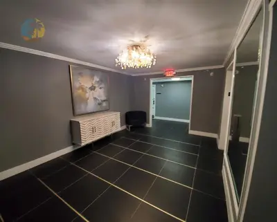 an empty hallway with a chandelier and a room at Alexander 1119 in Miami Beach