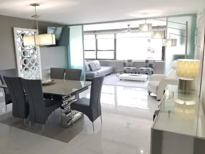 a dining room and living room with a table and chairs at Alexander 1121 in Miami Beach