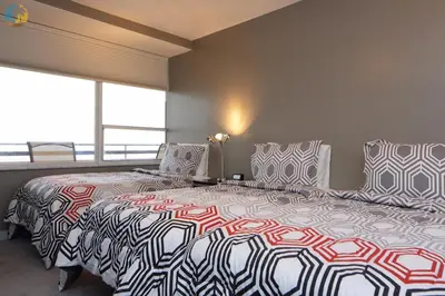a bedroom with two beds and a large window at Alexander 1121 in Miami Beach