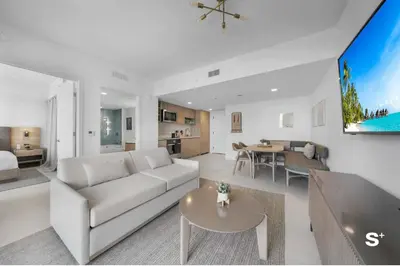 a white living room with a couch and a table at Stylish Downtown 1-BD Condo in Miami