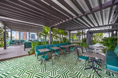 a restaurant with tables and chairs on a patio at Stylish Downtown 1-BD Condo in Miami