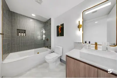 a bathroom with a tub and a toilet and a sink at Upscale 3-BD Condo in Downtown Miami in Miami