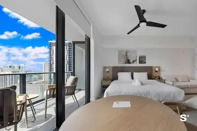 a bedroom with a bed and a table and a balcony at Luxury Studio in DTW Miami with City Views in Miami