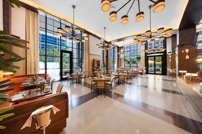 a restaurant with tables and chairs and windows at Luxury Studio in DTW Miami with City Views in Miami