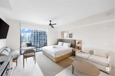 a bedroom with a bed and a living room at Chic Downtown Studio with City Views in Miami
