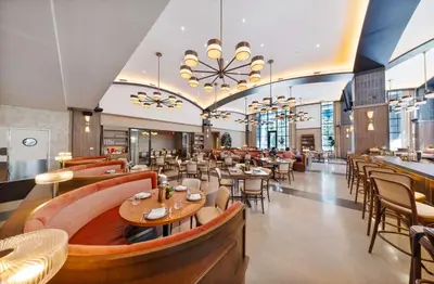 a dining room with tables and chairs and a restaurant at Chic Downtown Studio with City Views in Miami