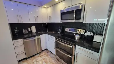 a kitchen with white cabinets and a microwave at Alexander 1420 in Miami Beach