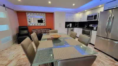 a kitchen and dining room with a table and appliances at Alexander 1420 in Miami Beach