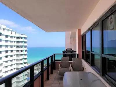 a balcony with chairs and a view of the ocean at Alexander 1618 in Miami Beach