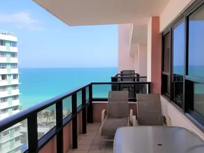 a balcony with chairs and a view of the ocean at Alexander 1618 in Miami Beach