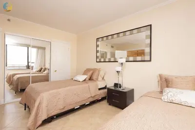 a bedroom with two beds and a mirror at Alexander 1620 in Miami Beach