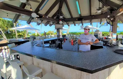 a man standing at a bar with a mask on at Alexander 1620 in Miami Beach