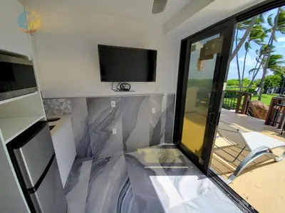 a living room with a tv and a sliding glass door at Alexander 1620 in Miami Beach