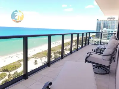 a balcony with a view of the beach and the ocean at Alexander 1701 in Miami Beach