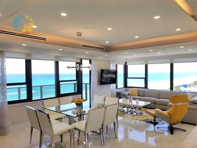 a living room with a table and chairs and a couch at Alexander 1701 in Miami Beach