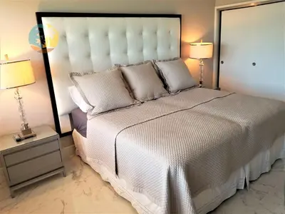 a bedroom with a large white bed with two lamps at Alexander 1701 in Miami Beach