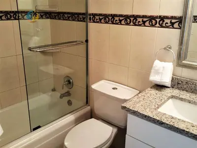 a bathroom with a toilet and a shower and a sink at Alexander 510 in Miami Beach