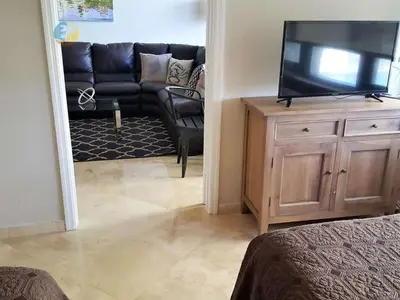 a living room with a television and a couch at Alexander 510 in Miami Beach