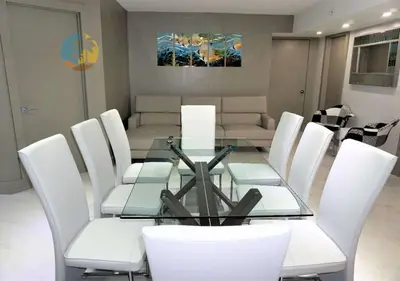 a dining room with a glass table and white chairs at Alexander 518 in Miami Beach
