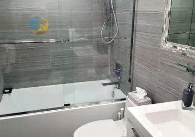 a bathroom with a toilet and a tub and a sink at Alexander 518 in Miami Beach