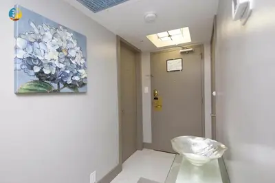 a hallway with a painting of flowers on the wall at Alexander 519 in Miami Beach