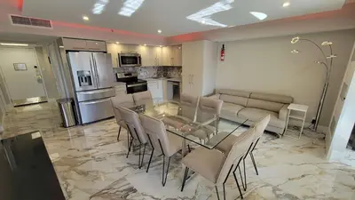 a kitchen and dining room with a glass table and chairs at Alexander 521 in Miami Beach
