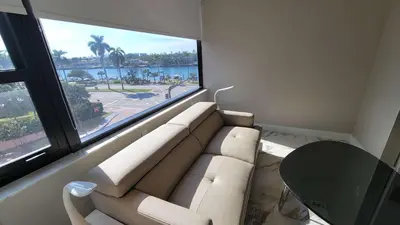 a living room with a couch and a large window at Alexander 521 in Miami Beach