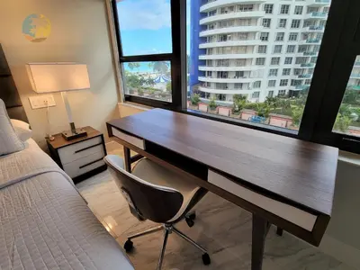 a desk with a chair in a room with a large window at Alexander 611 in Miami Beach