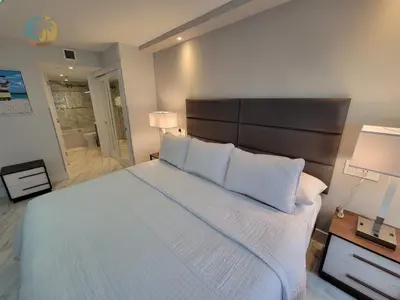 a bedroom with a large bed with white sheets and pillows at Alexander 611 in Miami Beach