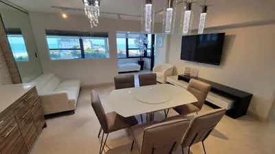 a dining room and living room with a table and chairs at Alexander 702 in Miami Beach