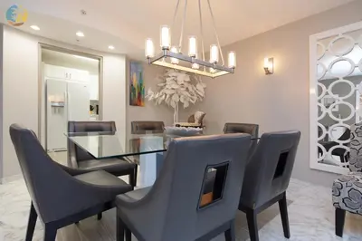 a dining room with a glass table and chairs at Alexander 718 in Miami Beach