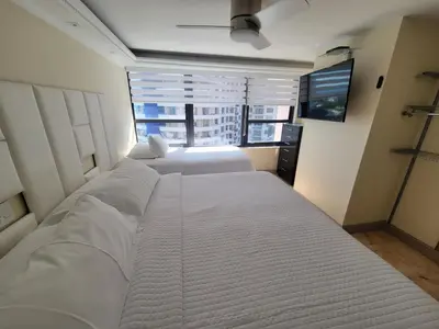 a bedroom with two white beds and a window at Alexander 807 in Miami Beach