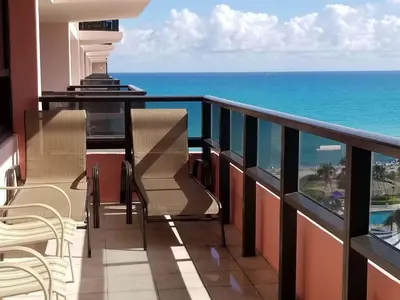 a balcony with chairs and a view of the ocean at Alexander 819 in Miami Beach